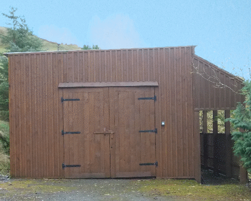 A huge barn with a covered walkway at the side. To keep hay, straw, tractor and tools - or whatever else you want it for!